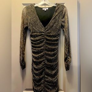 Black with gold shimmer ruched mini dress from Revolve. Brand is Steve Madden